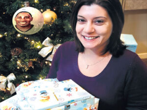 Jennifer Santoro with the Christmas presents Ellis Hobbs bought for her family at Toys 'R' Us.